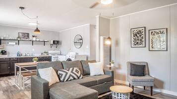 Relax in this stylish living space with a sectional sofa, coffee table, and armchair.