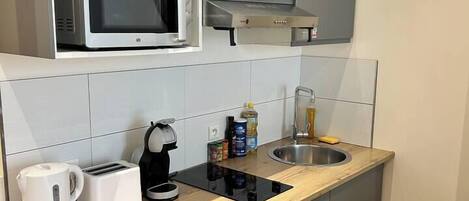 Fridge, microwave, coffee/tea maker, cookware/dishes/utensils