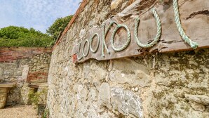 A rustic stone wall with a weathered sign that reads "Lookout". - Stardust (Ventnor)
