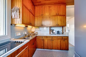 Enjoy cooking in this well-equipped kitchen with a stove, coffee maker, and toaster.
