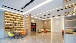 A modern interior with a central seating area, a bookshelf, and a dining table. - yi xuan hotel - bus station (Yangjiang)