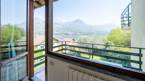 A balcony with a view of a lake and mountains.