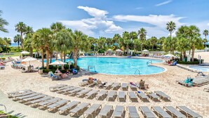 A pool area with sun loungers and palm trees. - St Lucia 306*Guest Favorite*HighEnd*ResortAmenites (Destin)