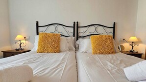 A double bed with white linens and two decorative pillows, flanked by nightstands with lamps. - Beautiful 2 bed apartment at La Torre Golf AO711LT (Murcia)