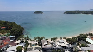 A coastal resort with a beach, clear waters, and lush greenery. - Ocean View Jacuzzi 3BR Kata Penthouse (Karon)