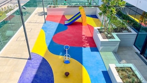 A playground with a colorful slide and soft play area. - Homesgetaway Spacious 2BR Apartment in Al Wasl 1 Residences (Dubai)