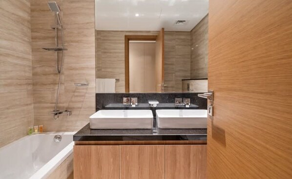 A modern bathroom with a double sink vanity, a shower, and a bathtub. - 2BR in Missoni Bldg 5 Mins to Burj Dubai Mall (Dubai)