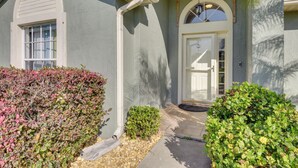 A house with a front entrance, a window, and a door.