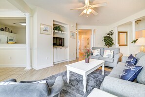 A living room with a white coffee table, grey sofas, and a ceiling fan. - 4 Golf Courses On-site: North Myrtle Beach Villa! (North Myrtle Beach)