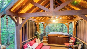 A wooden gazebo with a hot tub, red seating, and a view of the forest. - Hocking Hills 'social Distance Cabin' w/ Hot Tub (Laurelville)