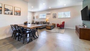 A spacious living area with a dining table, chairs, sofas, and a TV. - ‼️Morrison Getaway‼️ - 2BR House,  BBQ , Free Parking (Morrison)