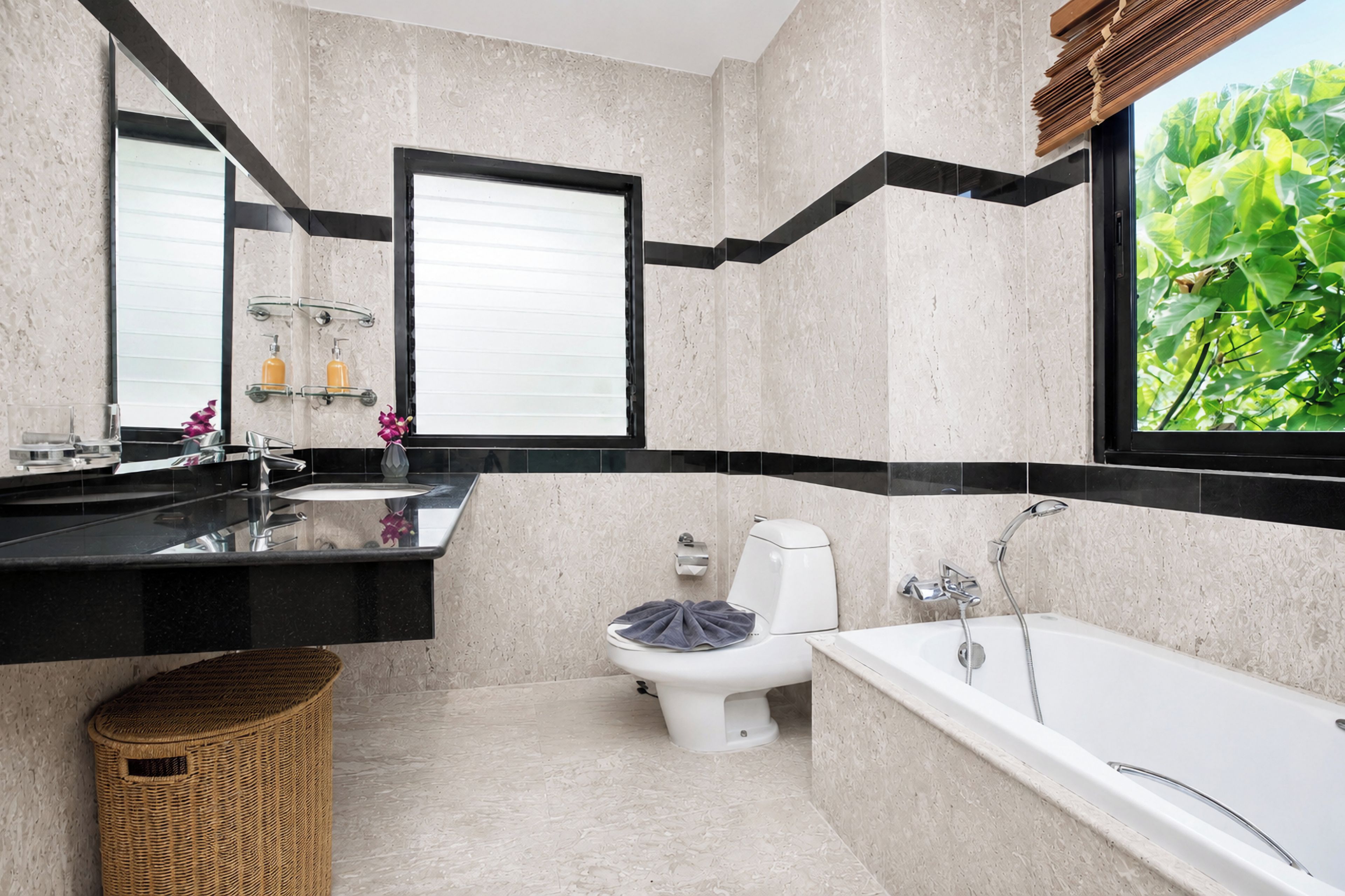 A modern bathroom with a large bathtub, a toilet, and a sink area.