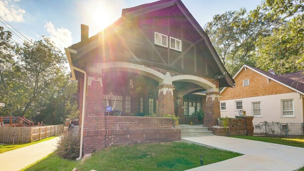 A two-story house with a brick exterior, a covered porch, and a well-maintained lawn. - 1 Mi to Dtwn: Welcoming Macon Home w/ Yard (Macon)