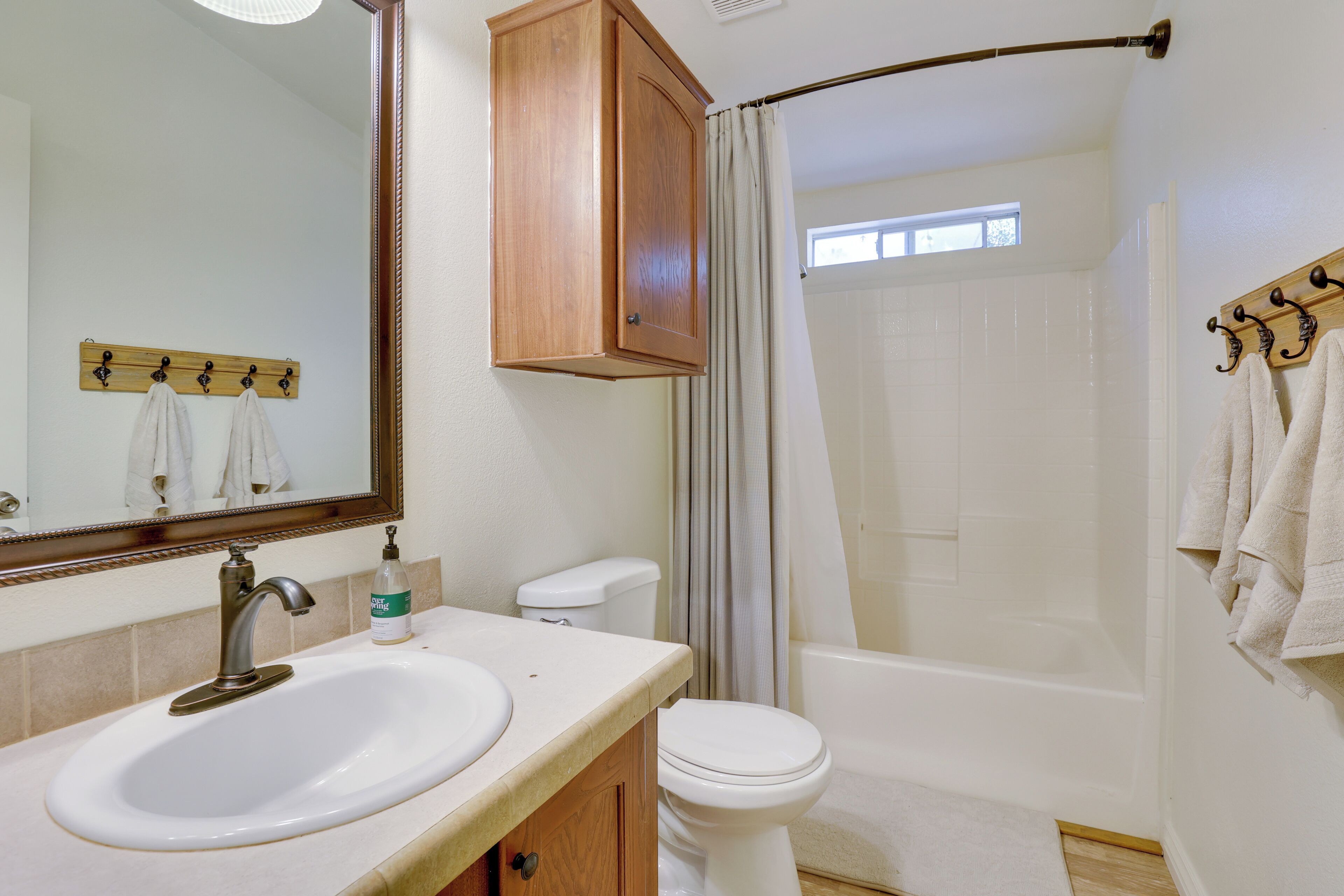 A bathroom with a sink, toilet, and shower.