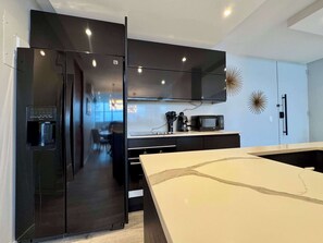 Fridge, microwave, coffee/tea maker, cookware/dishes/utensils