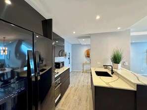 Fridge, microwave, coffee/tea maker, cookware/dishes/utensils