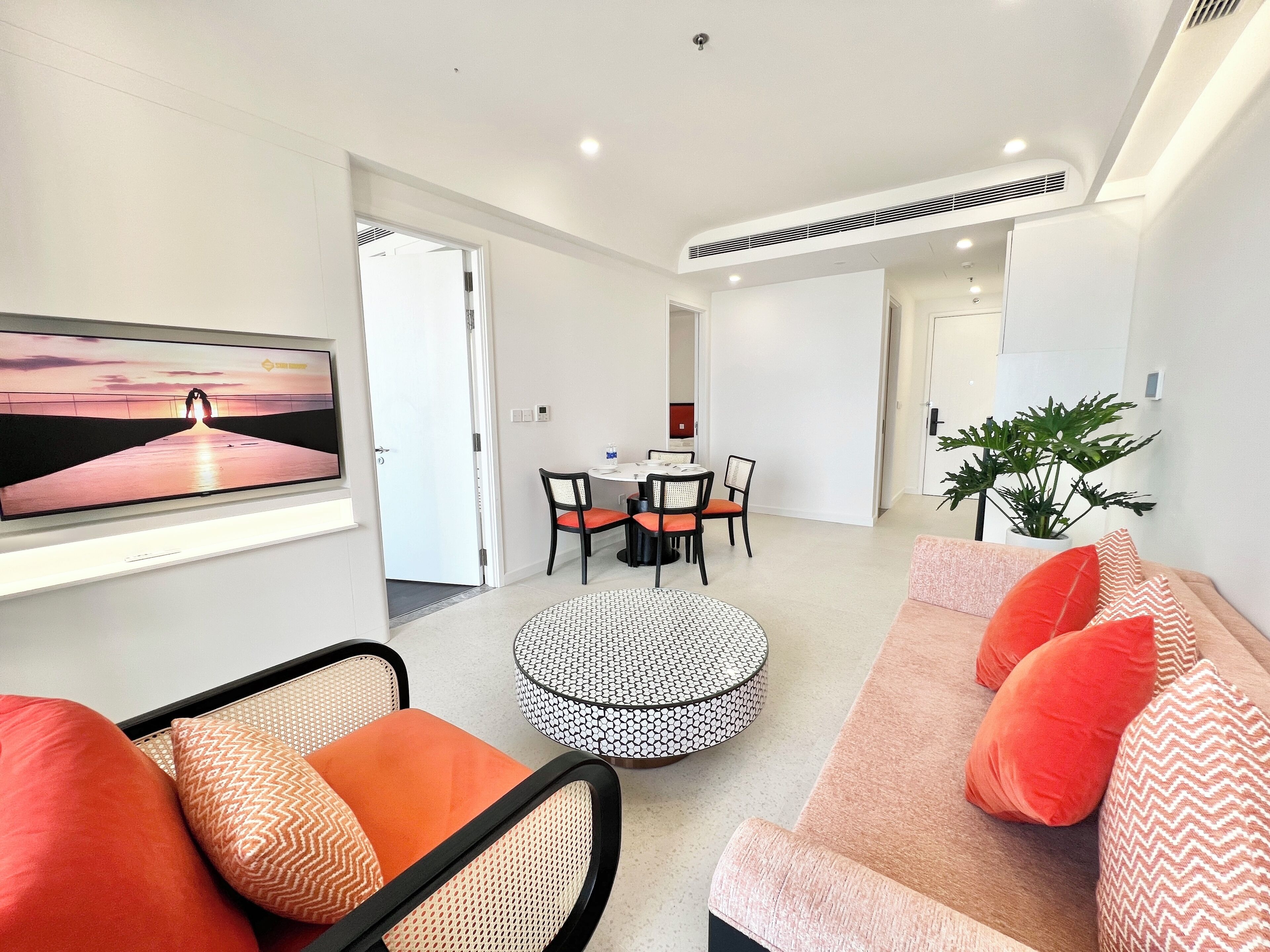 Un salon moderne comprenant un canapé, une table basse et un coin repas avec des chaises et une table.
