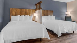 A hotel room with two beds, wooden headboards, white bedding, bedside lamps, and a chair. - Extended Stay America Premier Suites - Yuma (Yuma)