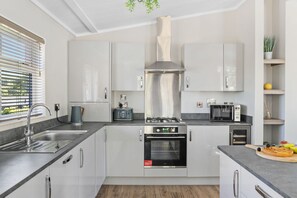 Enjoy cooking in this well-equipped kitchen with a gas stove, oven, and microwave, along with a convenient island workspace.