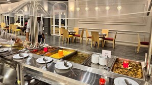 A buffet setup with multiple food stations, including rice, vegetables, and meat dishes. - oriental grand plaza (Tenth of Ramadan City)