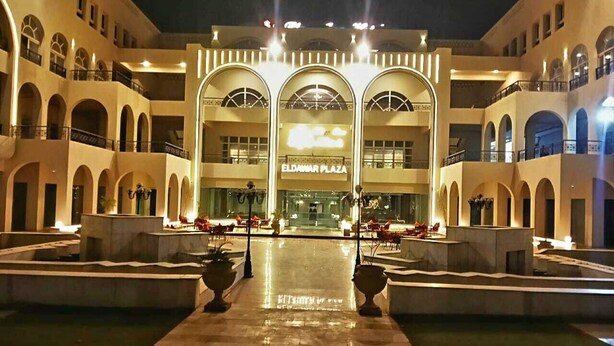 The exterior of Eldamar Plaza hotel with a central courtyard, arched balconies, and a reflective water feature. - oriental grand plaza (Tenth of Ramadan City)