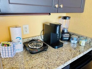 Fridge, microwave, coffee/tea maker, cookware/dishes/utensils