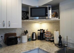 Fridge, microwave, stovetop, coffee/tea maker