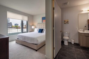 Enjoy a city view from the window, with a large bed and convenient bedside table nearby.
