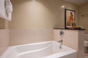 A bathroom with a bathtub, a toilet, and a framed artwork on the wall. - Honua Kai | Ocean View 6 BR, Sleeps 20 | Car Incl. w/ 6+ Nights | HKH ML-1085 by KBM (Lahaina)