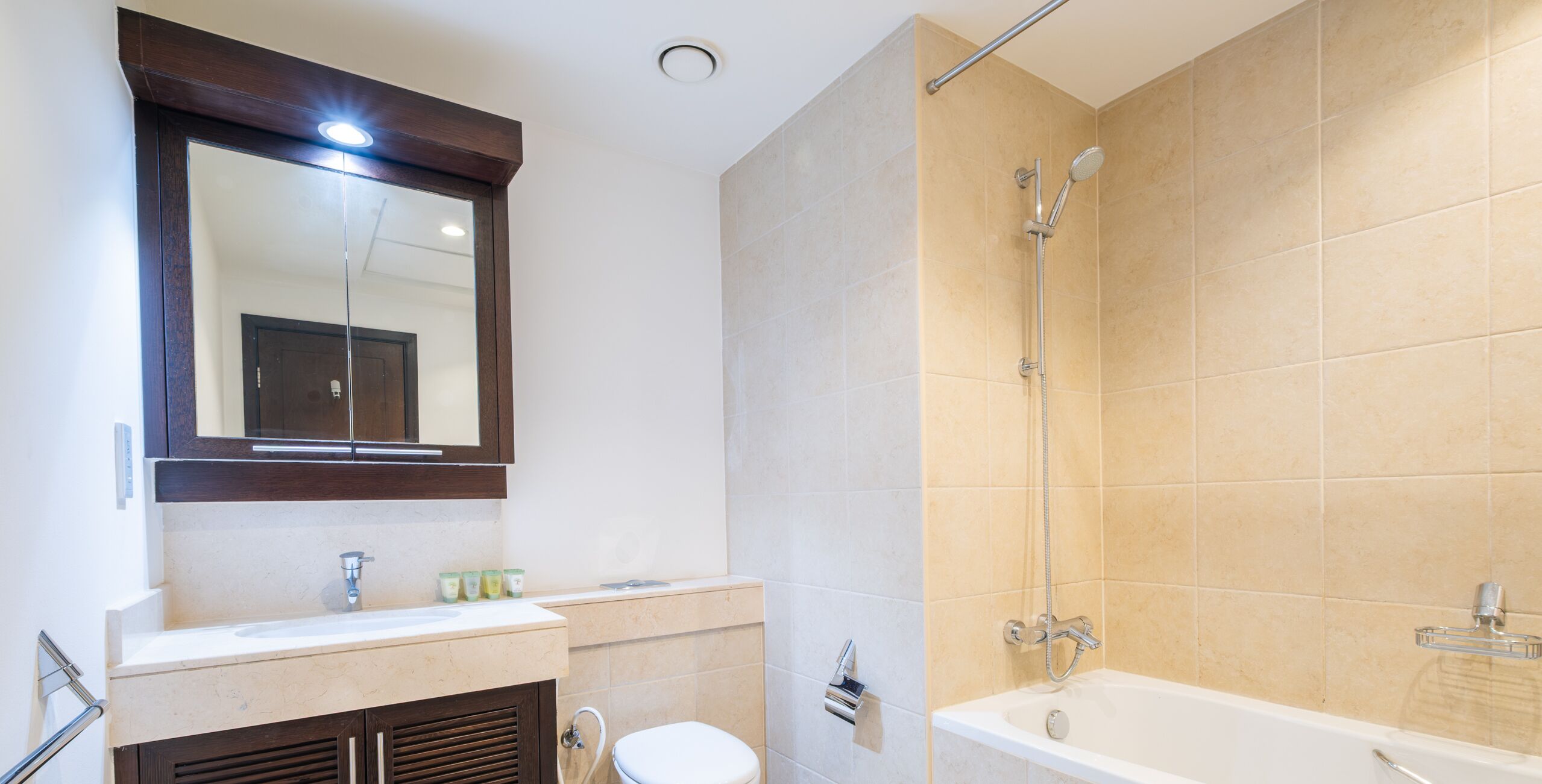 A bathroom with a sink, toilet, and bathtub.