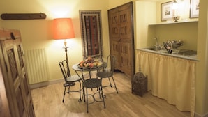 A dining area with a table set for four, a lamp, and a decorative door. - Porta Palace Apartments (Turin)