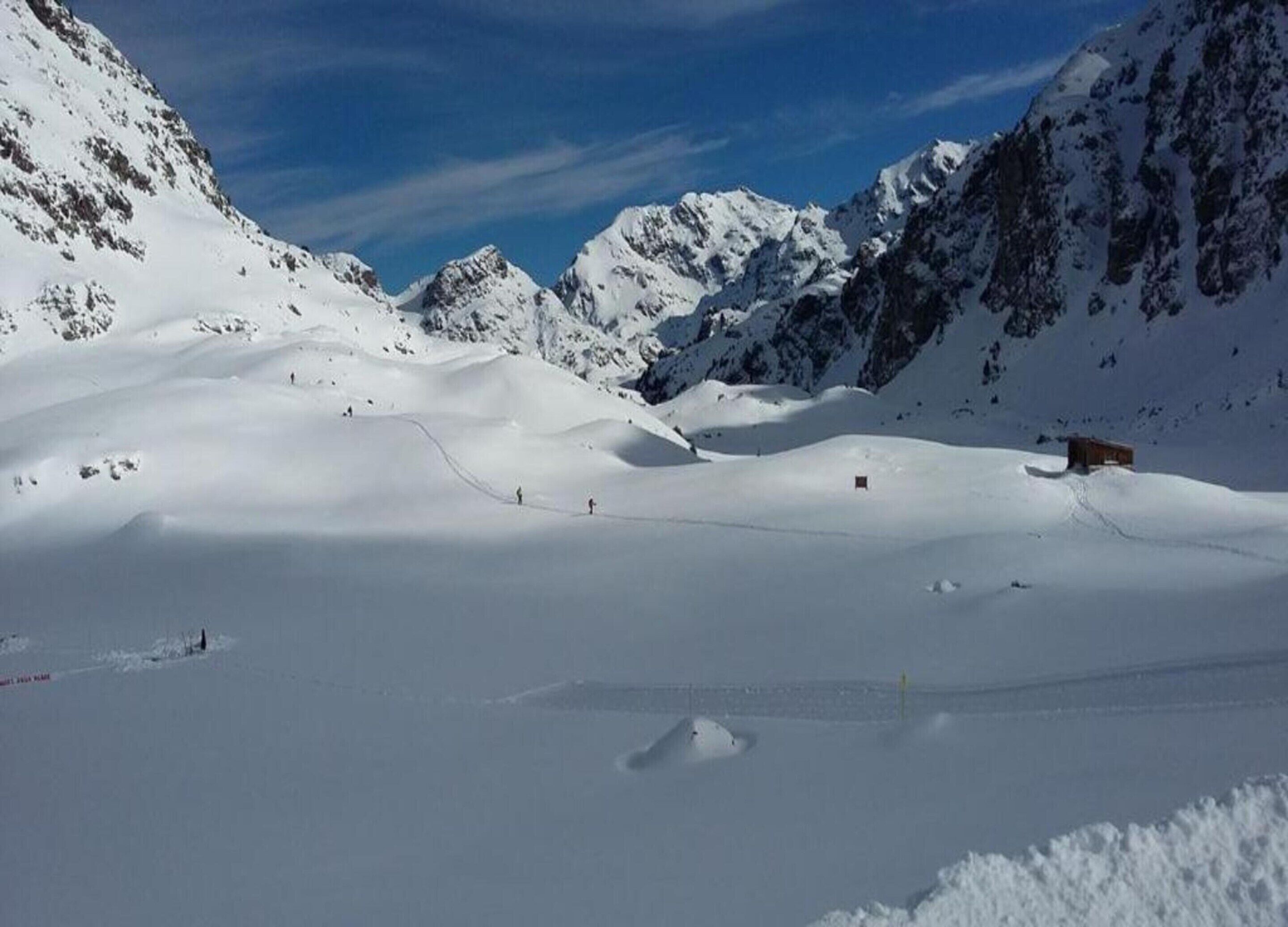 A snow-covered mountain landscape with a small cabin.