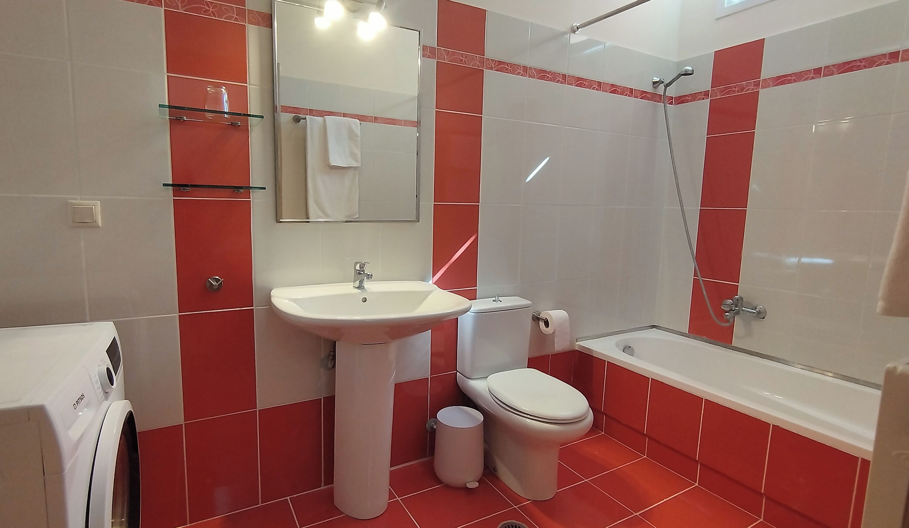 A bathroom with a sink, toilet, and shower.