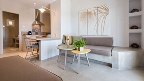 A modern living space with a kitchen, dining area, and seating area. - Michael Zeppos Studios, Naousa (Paros)