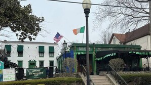 A building with a green awning and a sign for 'Irish Pub & Restaurant'.