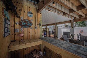 A wooden interior with a sign reading 'The Tip-Sed Turtle,' a wooden bench, and a table with chairs.