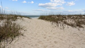 A sandy beach path with dunes and sparse vegetation. - 3BR - Dogs OK! Near the Pointe ~ Hello Sunshine (Emerald Isle)