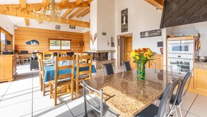A spacious kitchen with granite countertops, wooden cabinets, and a large island.