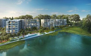 Un complesso residenziale moderno con diversi edifici, una fontana centrale e aree verdi circostanti.