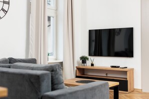 Departamento Confort, 2 habitaciones, para no fumadores, vista a la ciudad | Área de sala de estar | Televisión LED de 50 pulgadas con canales digitales