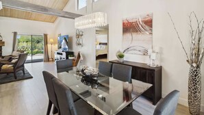 A modern dining area with a glass table, dark chairs, and a decorative centerpiece. - Club Ironwood Resort Access, Desert Garden & Golf (Carefree)