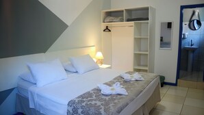A hotel room with a bed, a wardrobe, a mirror, and a bathroom. - Metro Hotel (Aguas de Lindoia)
