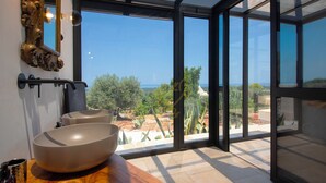 A bathroom with a large window, two sinks, and a wooden vanity. - TD ApulianRetreat Scenic Villa with hammam & pool (Costa Merlata)