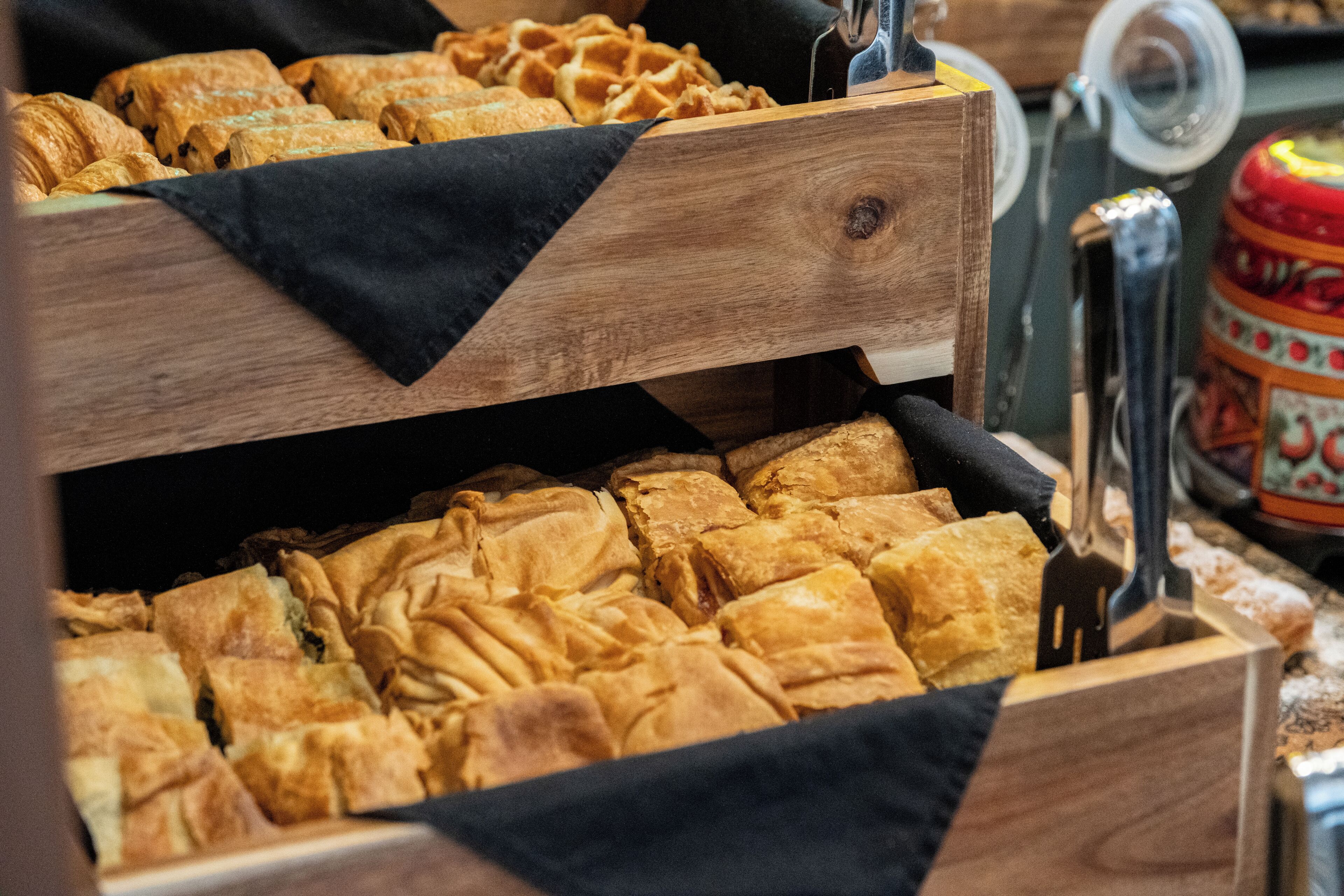 A wooden display case with pastries.