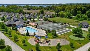 A residential area with houses, a swimming pool, and a playground. - The Snowberry - 67 Butternut (Prince Edward)