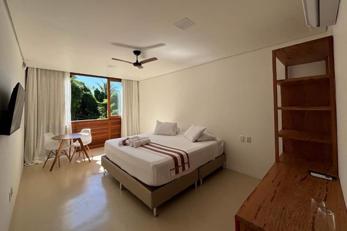 A modern bedroom with a bed, a desk, and a chair.