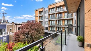 A modern apartment building with multiple balconies, large windows, and a clear sky. - Comfy 2BD Home | Accommodates 6 | Near Art Museum (Philadelphia)