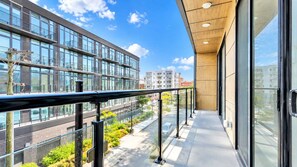 A modern building with large windows and a balcony with a metal railing. - Stylish 1BD Near Schuylkill River | Fits 2 Comfort (Philadelphia)