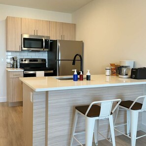 Dishwasher, coffee/tea maker, cookware/dishes/utensils