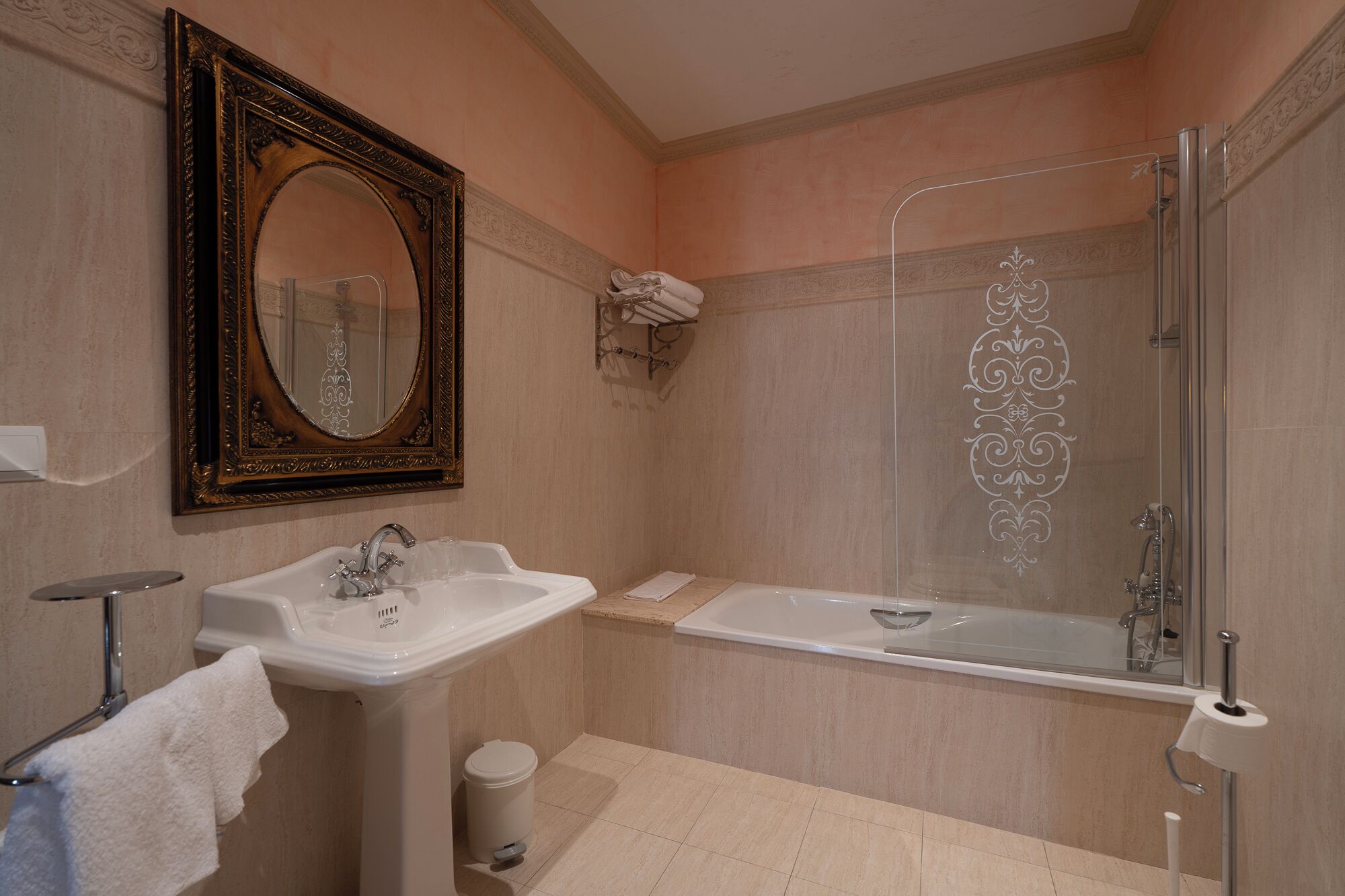 A bathroom with a sink, mirror, bathtub, and shower.